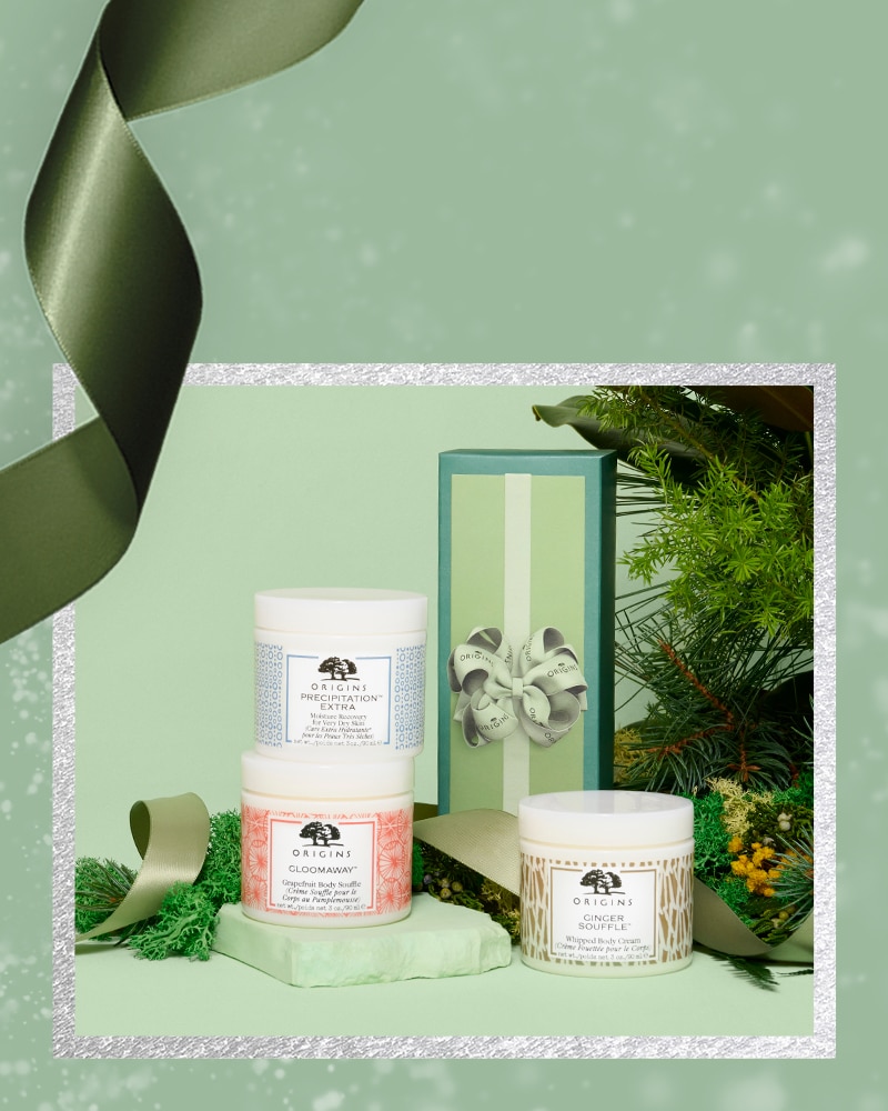 Origins souffle sampler holiday set with green festive background