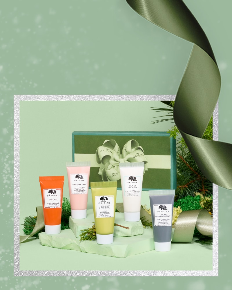 Origins mask holiday set with green festive background